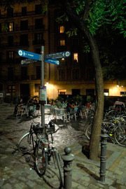 night shot of bike chained to sign post on plaza in Barcelona
