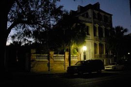 night shot of Charleston Single House on Meeting Street in Charleston, South Carolina
