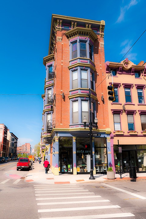 4-story Italianate mixed-use building painted in celebratory fashion in Cincinnati, Ohio’s Over-The-Rhine neighborhood