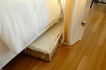 basket under bed in Katrina Cottage VIII