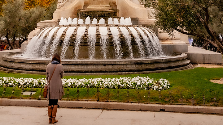 woman standing in front of semicircular fountain in Madrid
