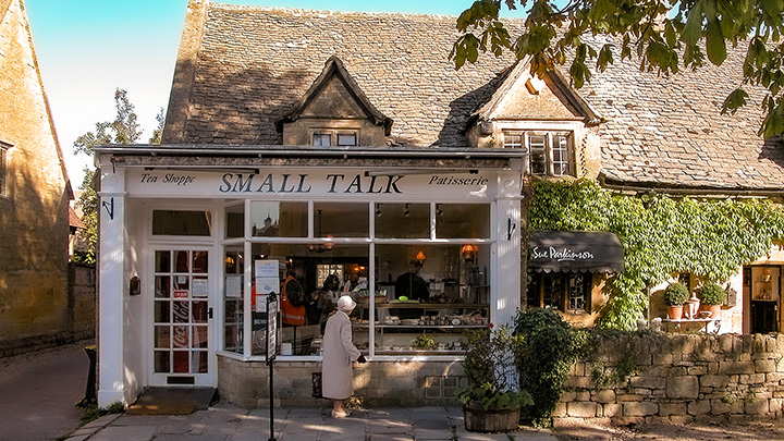woman in front of storefront along High Street in Broadway, England