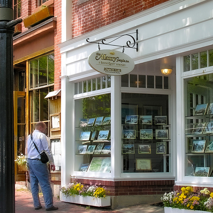 shopper just a few feet from blade sign on Main Street in Nantucket