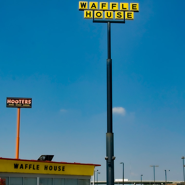 Waffle House sign towering over Waffle House itself