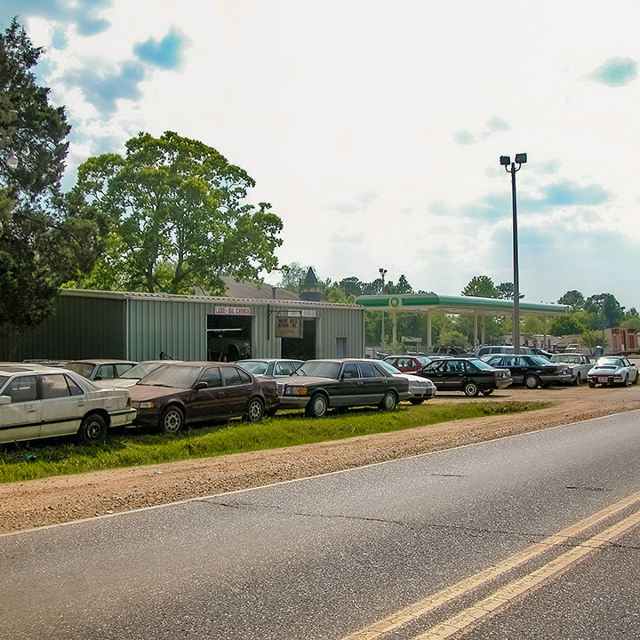 car repair shop littered with cars out to the street