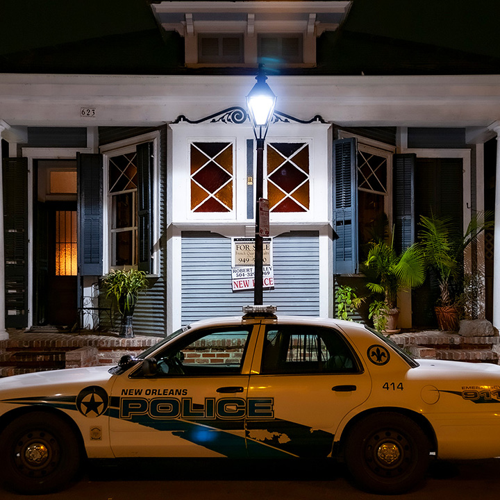police car parked in front of French Quarter house