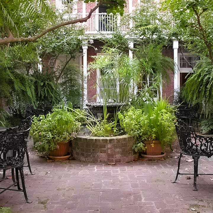 New Orleans French Quarter courtyard focused on iron fountain