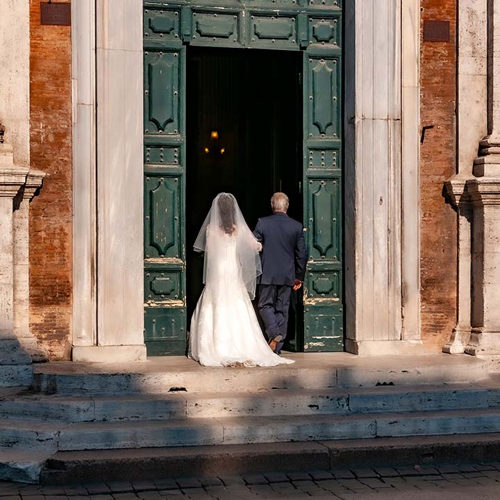 father and bride entering church in Rome, Italy