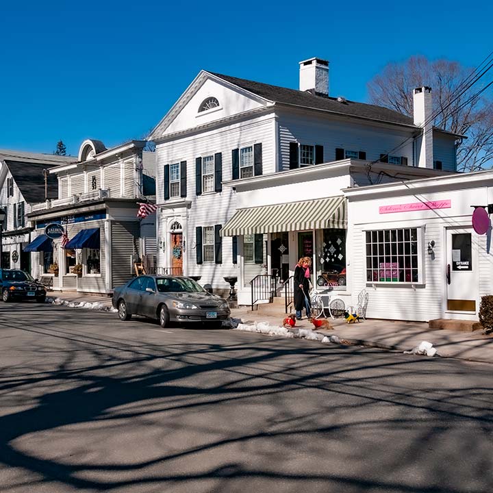 white shop fronts in Essex, Connecticut glow on a crisp winter noontime