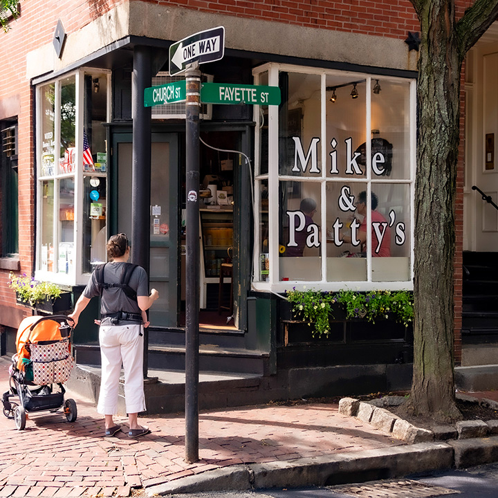mother with baby stroller waiting for a seat at Mike & Patty's, a Boston favorite
