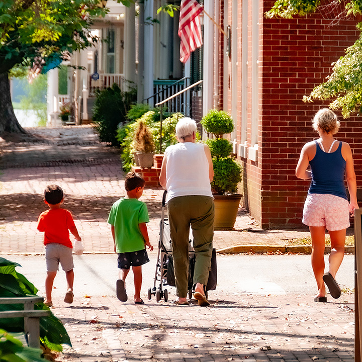 grandmother, mom, and two children walking home from the bakery