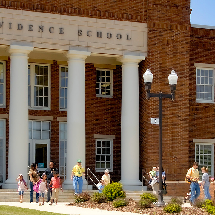 parents at Providence School waiting to walk their children home