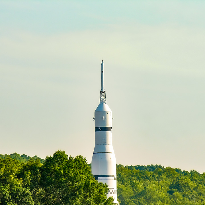 Saturn I rocket peeking above the treetops at the US Space & Rocket Center