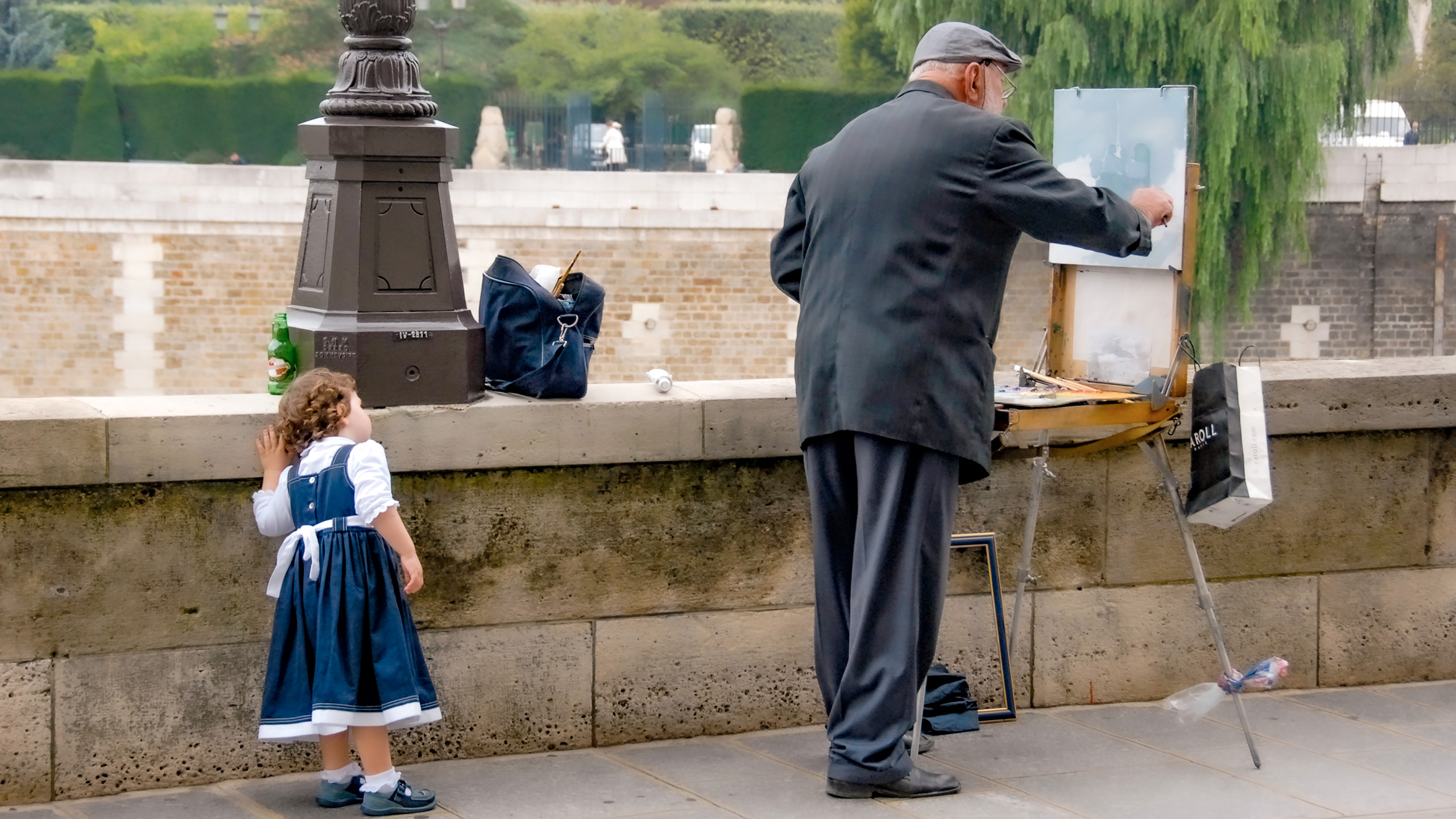 little girl watching painter behind Notre Dame in Paris
