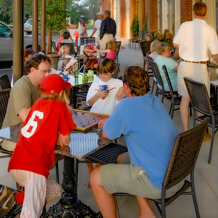 fathers and sons playing checkers on the town square at the Waters in Pike Road, Alabama